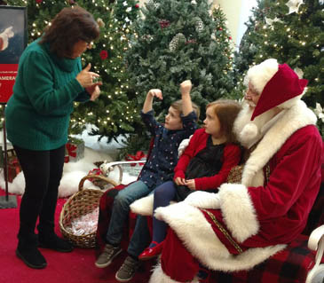 Santa along with support from an American Sign Language (ASL) Interpreter discuss holiday wish lists!