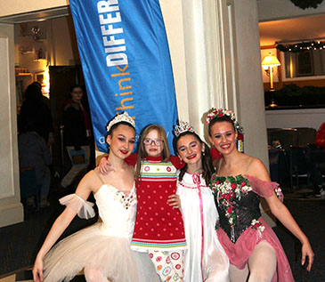 Some of the New Paltz Ballet Company’s dancers pose with a young friend of ThinkDIFFERENTLY in the lobby of the Bardavon in front of a ThinkDIFFERENTLY feather flag. This performance was a partnership with Dutchess County Tourism, Art Mid-Hudson, the Bardavon 1869 Opera House and ThinkDIFFERENTLY. 12/9/22