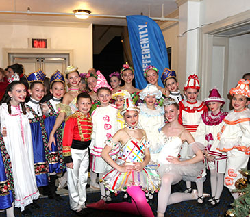 The New Paltz Ballet Company’s dancers (dressed in various colorful costumes from the performance) in the Bardavon Lobby in front of a ThinkDIFFERENTLY feather flag after their performance. This performance was a partnership with Dutchess County Tourism, Art Mid-Hudson, the Bardavon 1869 Opera House and ThinkDIFFERENTLY. 12/9/22