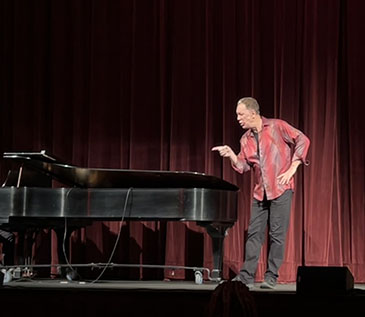 David Gonzalez performed “Cuentos- Tales from the Latino World” at the Bardavon, in partnership with Art Mid-Hudson and Dutchess County Tourism. David is standing in front of the piano and is pointing to his right as part of his story telling. 3/16/23