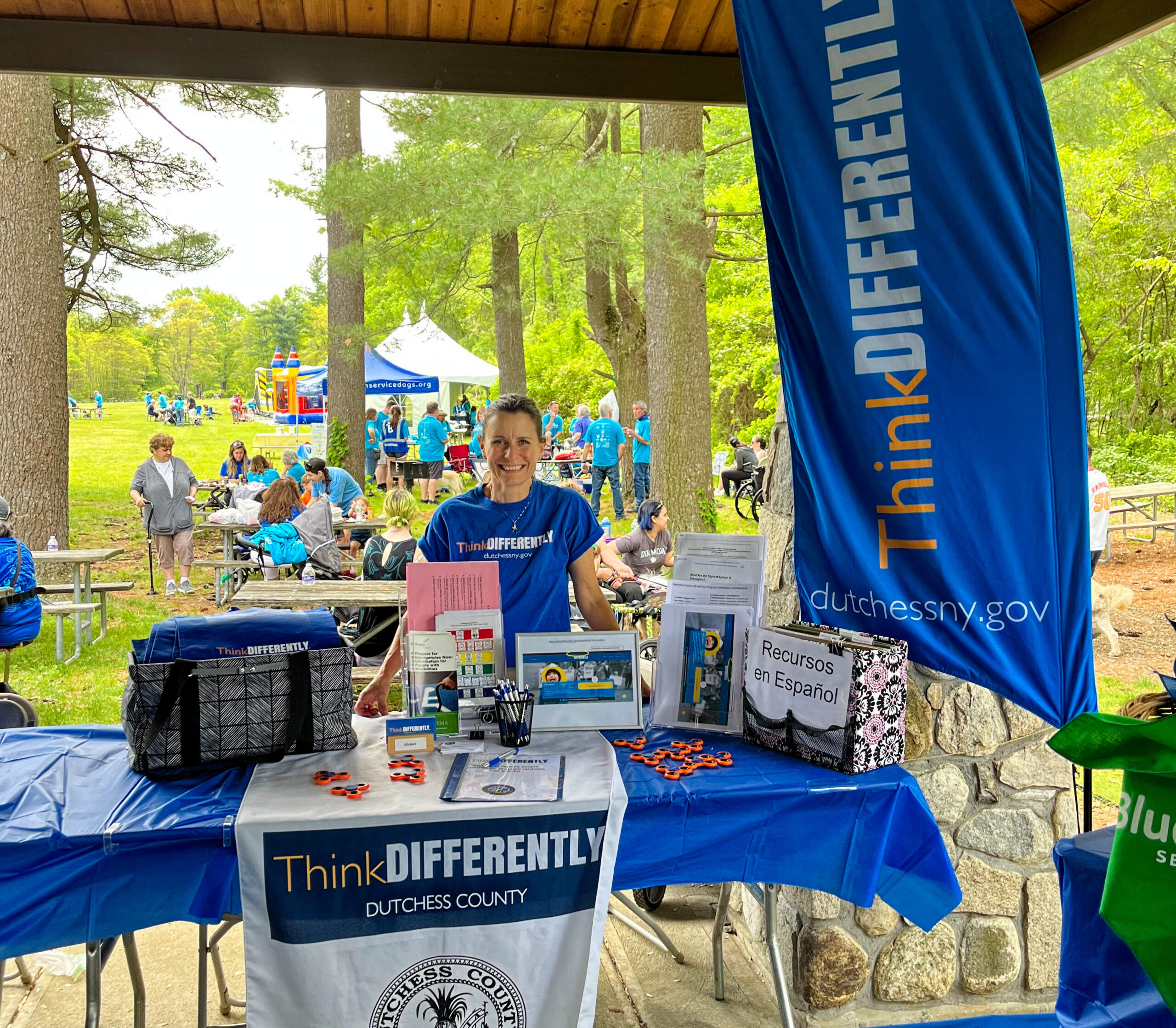 On May 13, 2023 BluePath Service Dogs held their Annual Walkathon at FDR Park in Yorktown. ThinkDIFFERENTLY was a sponsor and tabled at the event, which was attended by hundreds of people and maybe even more pups!! In this picture Dana Hopkins, Dutchess County All Abilities Program Director, is at the ThinkDIFFERENTLY table where she provided, information, resources, fidget spinners, and bags to the attendees, while making new connections and friends.