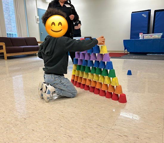 On April 29th, 2023 Dutchess County Department of Behavioral & Community Health hosted their 2nd Annual YOUR Health Fair at Dutchess Community College’s Falcon Hall. A young person engages in the Early Intervention/Preschool Special Education colorful cup pyramid.