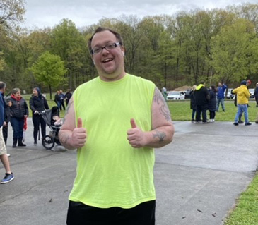 An young man dressed in a lime green shirt and black shorts, didn’t let the weather hinder his enthusiasm by showing two thumbs up during the walk! 2023 Autism Directory Services Walk for Autism at James Baird Park on Saturday April 29, 2023