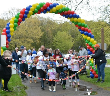 The teams are ready to at the 2023 Autism Directory Services Walk for Autism at James Baird Park on Saturday April 29, 2023. Individuals of all ages line up behind the rainbow colored paper chain and under the rainbow colored balloon arch that signifies the start of the walk. April 2023