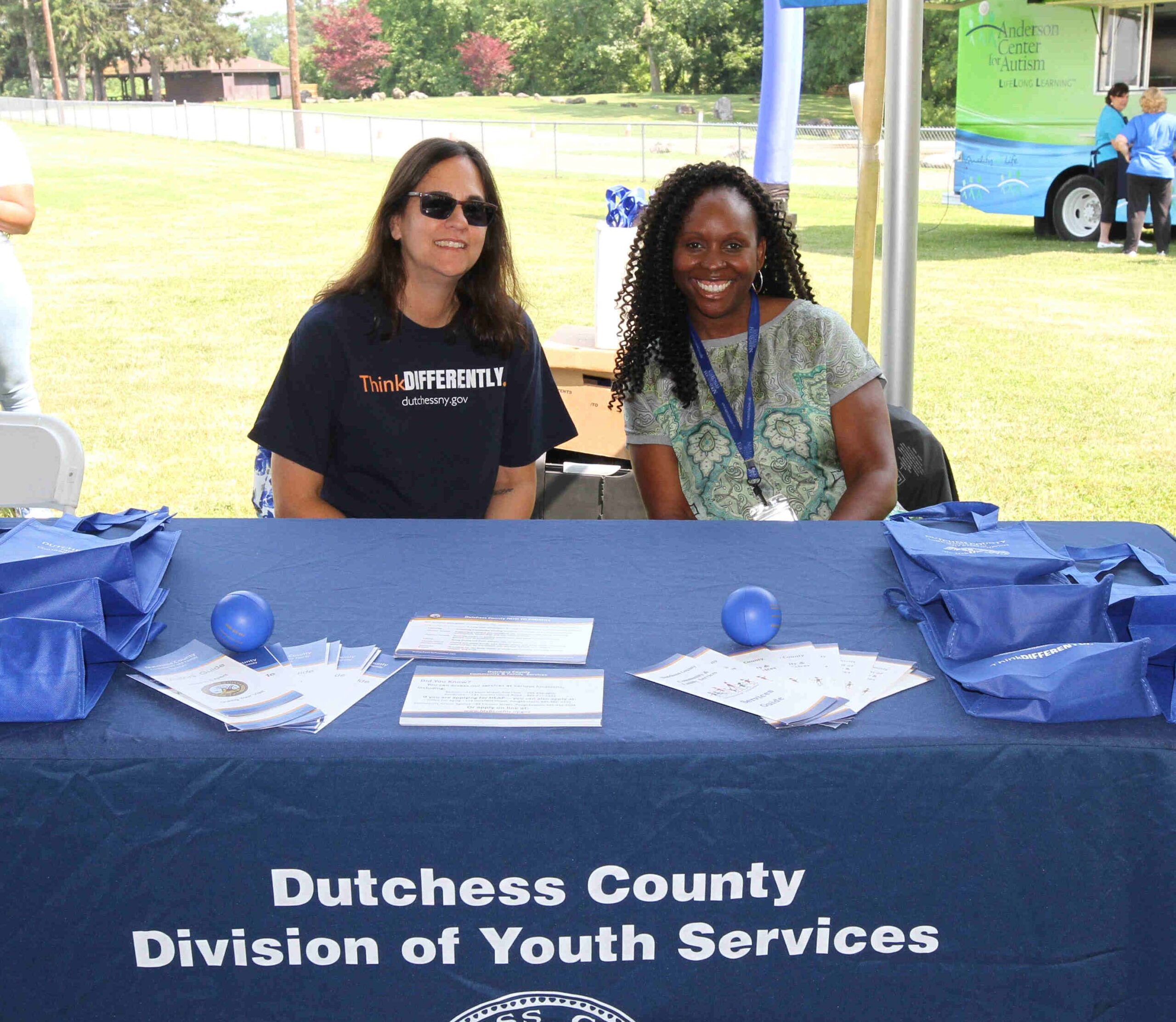 Approximately 40 different partner agencies, businesses and county departments joined us at the 3rd Annual ThinkDIFFERENTLY Fitness & Field Day on Friday June 29, 2023 at Bowdoin Park. Here Corrine and Karmen, from Dutchess County Division of Youth Services smile to the attendees while providing them with valuable information on resources and a fun blue stress ball.