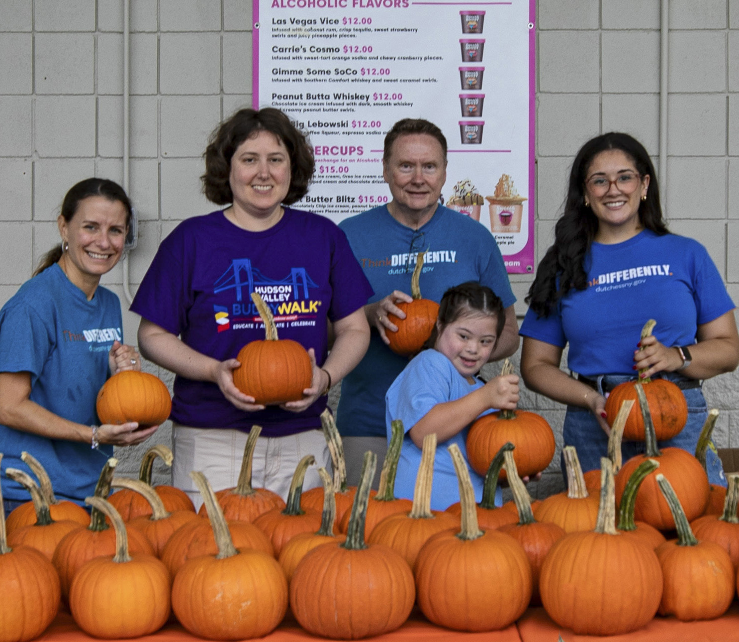 The ThinkDIFFERENTLY staff were found handing out pumpkins to participants of the Down Syndrome Association of the Hudson Valley’s annual Buddy Walk at Heritage Financial Park on October 7, 2023. Left to right, Dana Hopkins, All Abilities Program Director; Kara Cerilli, Photographer for the day and Dutchess County Employee; David McGorry, ThinkDIFFERENTLY Outreach Coordinator; Cara; and Olivia Clark, Coordinator of Intellectual and Developmental Disability Services for Dutchess County.