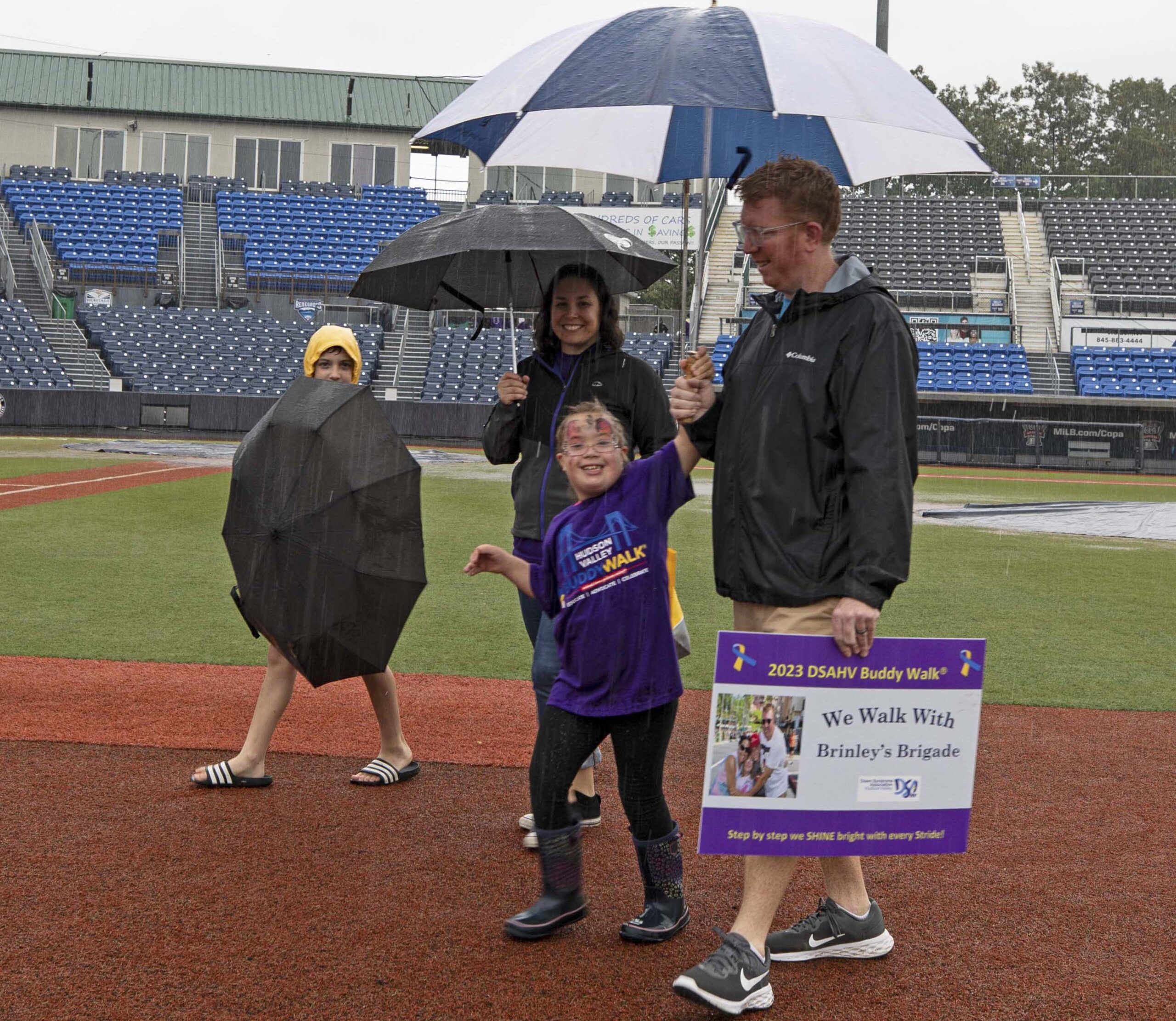 We walk rain or shine! Go Brinley’s Brigade! A family of 4 walks the baseline at Heritage Financial Park in support of Brinley’s Brigade! Down Syndrome Association of the Hudson Valley’s annual Buddy Walk at Heritage Financial Park on October 7, 2023